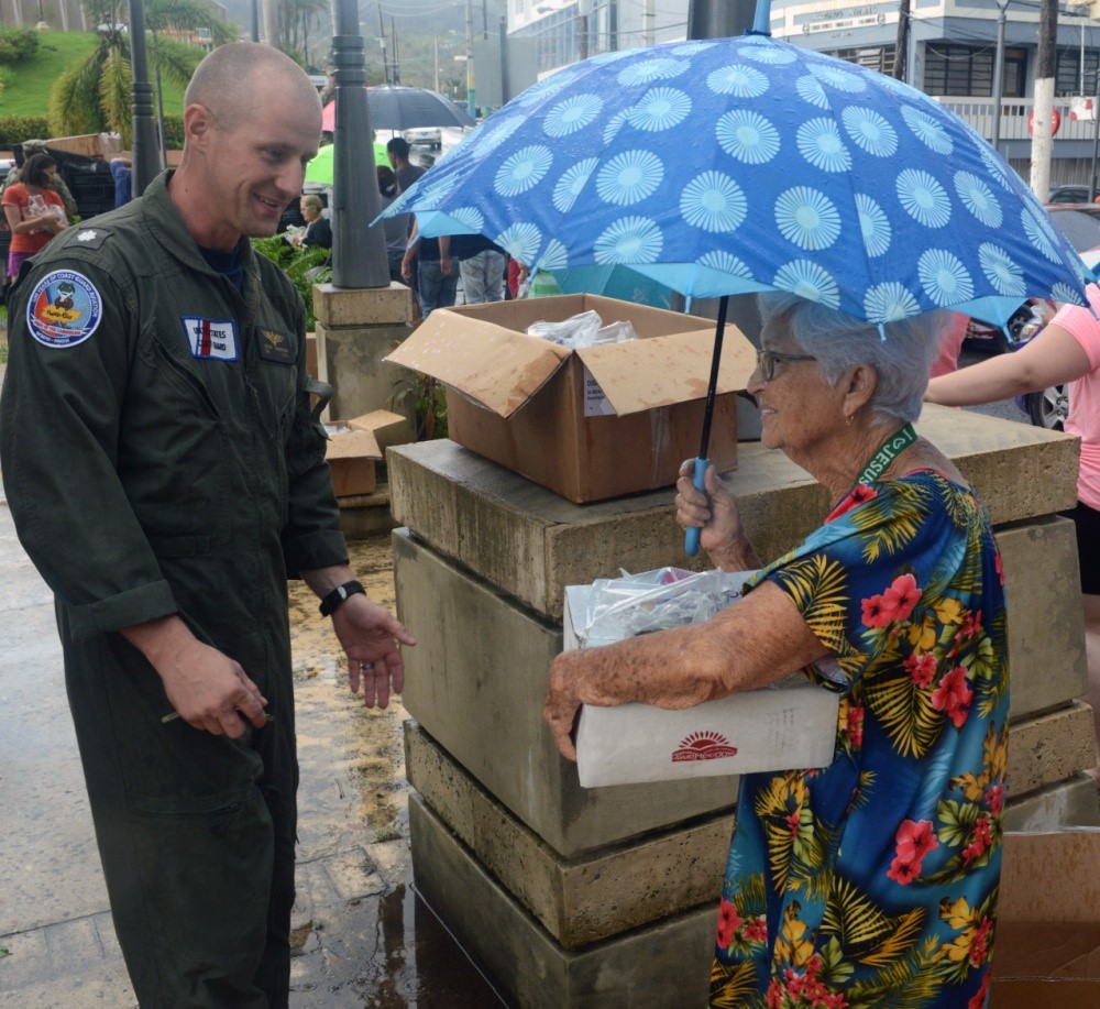 Air Station Borinquen Operations Officer, CDR Jeremy Anderson, delivered relief supplies to residents in Moca, Puerto Rico, following the hurricane. (U.S. Coast Guard) Air Station Borinquen Operations Officer, CDR Jeremy Anderson, delivered relief supplies to residents in Moca, Puerto Rico, following the hurricane. (U.S. Coast Guard)